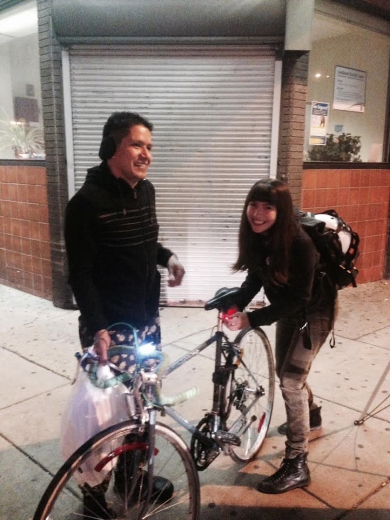 Pati helps a South Philadelphia community member get his new bike light all set up.