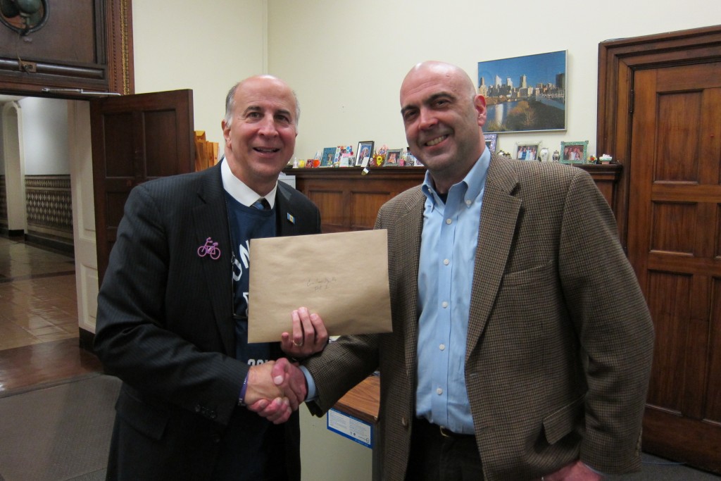 Bicycle Coalition policy coordinator (right) meets with Councilman Mark Squilla (left) to drop off the Bike Lane Toolkit documents.