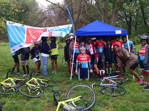 Post race youth decided to get away from the rain by huddling under a tent.