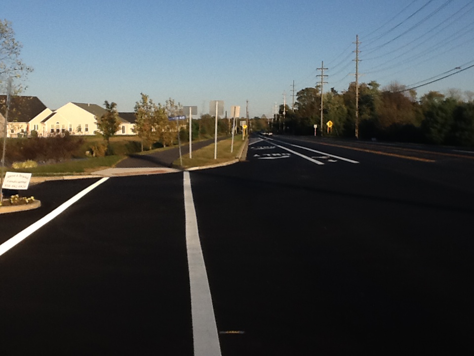 A suburban bike lane and an asphalt sidepath on Academy St in Clayton, NJ