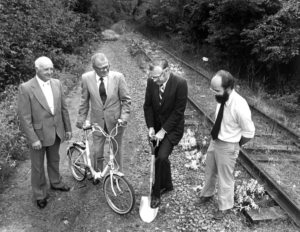 Bob McConnell, the Executive Director of the Fairmount Park Commission (left), two unknown Montgomery County Commissioners, and Jim Campbell of the Southeastern Pennsylvania Sierra Club (right) at the groundbreaking of the Schuylkill River Trail, in 1979.