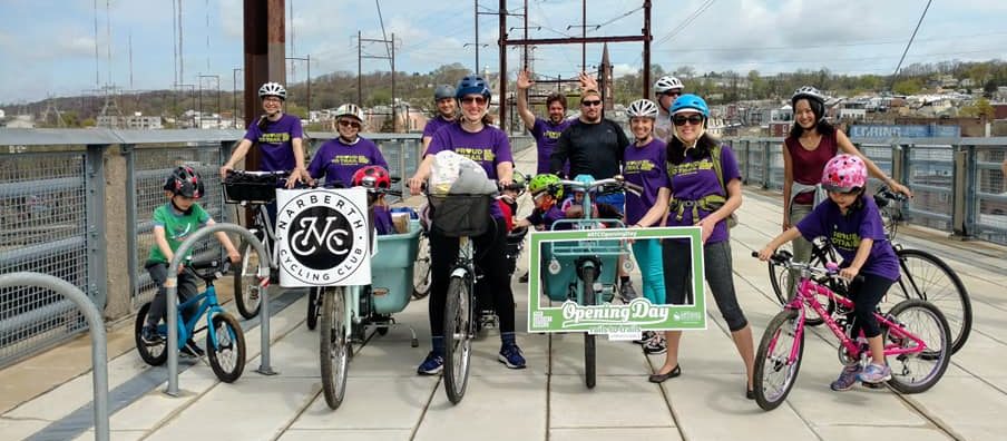 about 15 members of the Narberth Cycling Club pose for a group pic on the Manayunk Bridge on "Opening Day For Trails," an annual Circuit Trails event