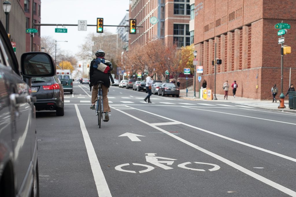 Cyclist riding in bike lane on Walnut Street in Philadelphia