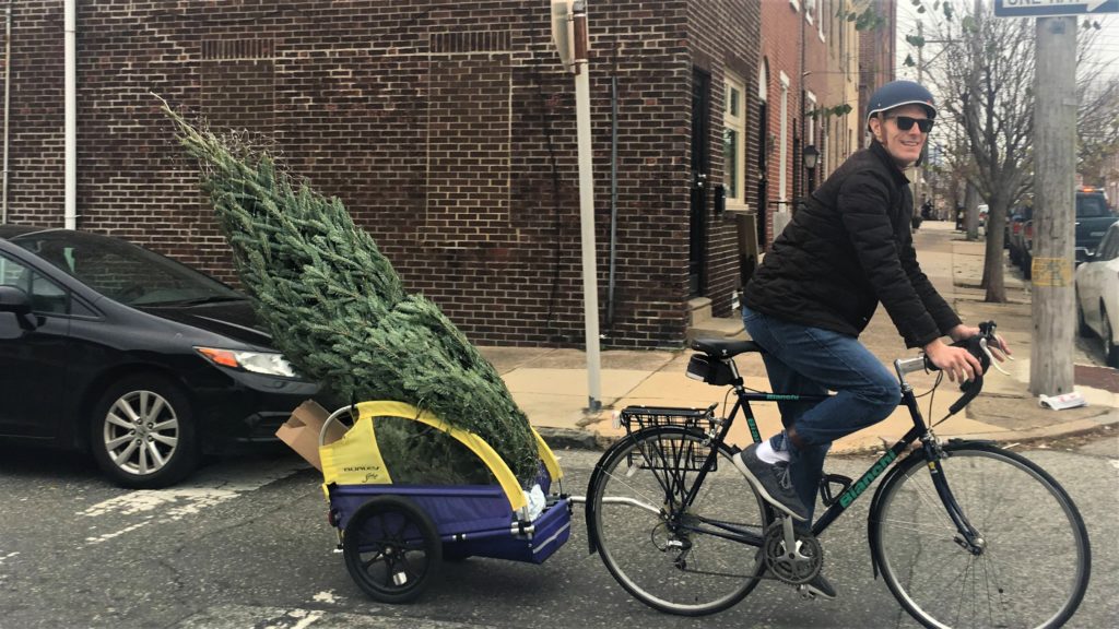 Matt Ludwig bikes with a Christmas tree in his bike trailer!