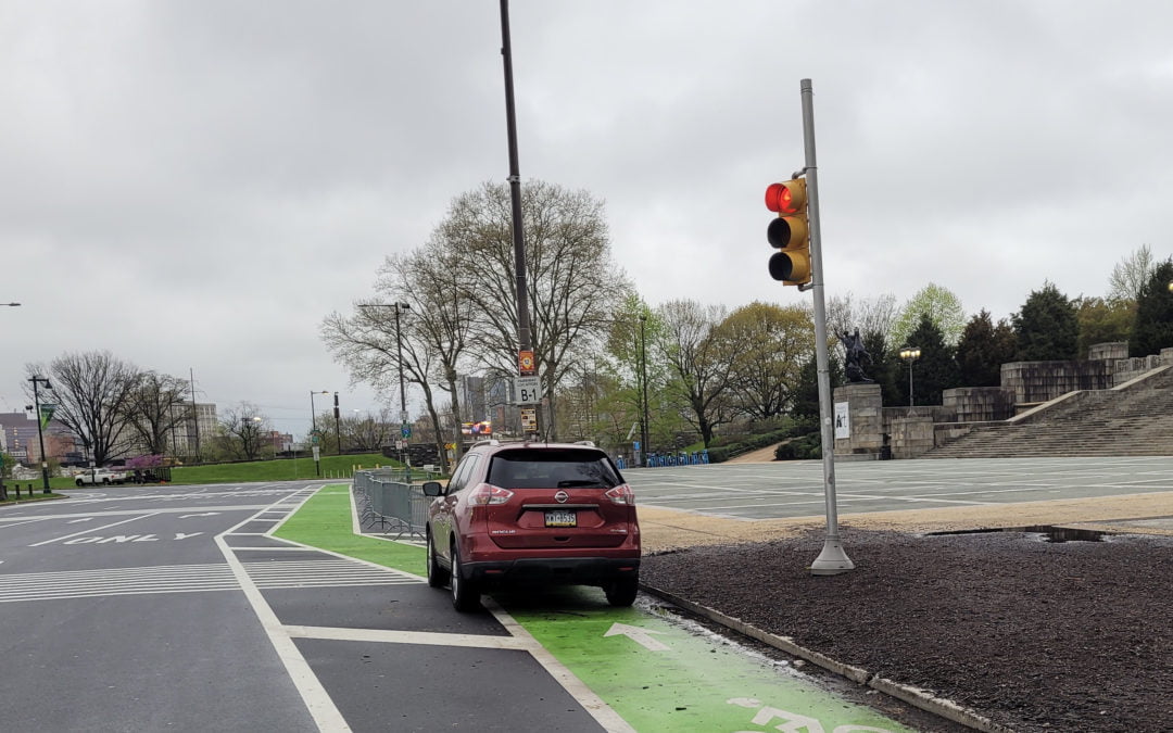 Image of a car parked in the bike lane on the Art Museum apron, near where a cyclist was killed the weekend of April 24, 2021