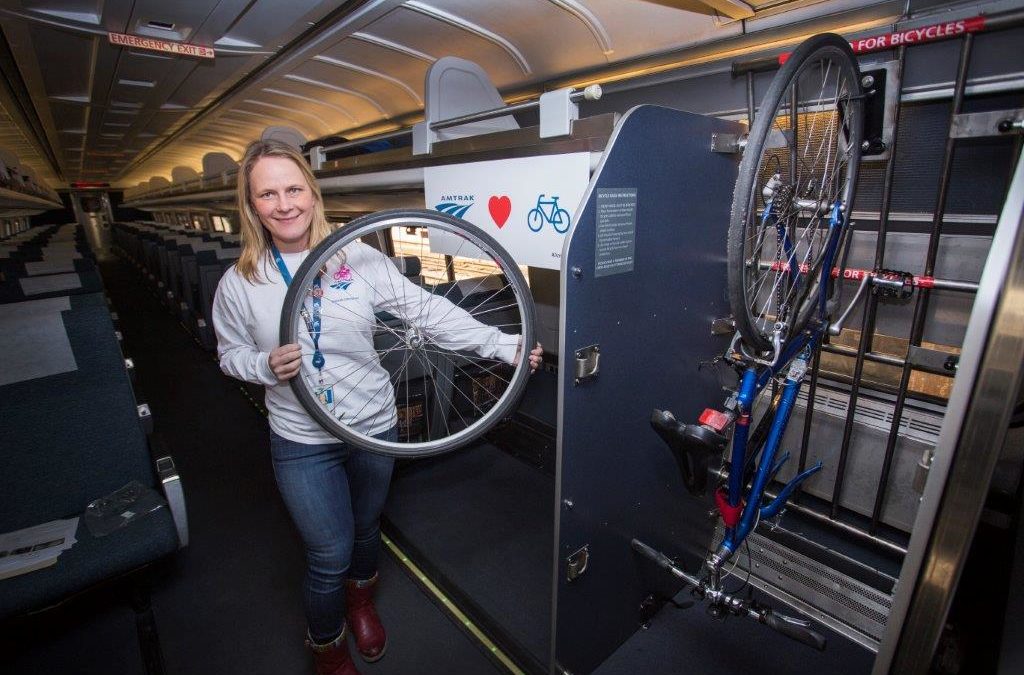 An Amtrak staffer demonstrates wheel removal for hangin your bike on the train.