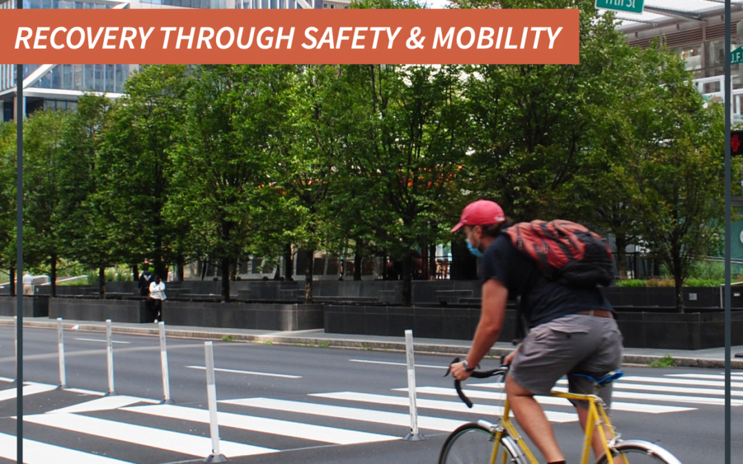 Person wearing a mask and biking in a protected bike lane with the words Recovery Through Safety and Mobility above